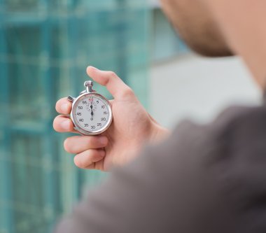 Man Holding A Stopwatch  clipart